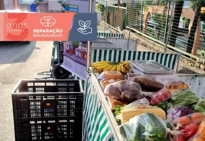 Foto de feira da agricultura familiar com selo que diz "Brumadinho 3 anos"