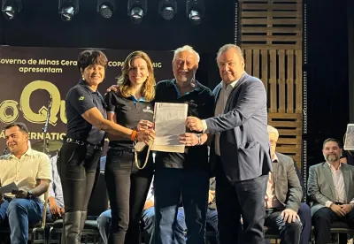 Quatro pessoas posando para a foto mostrando documento que firma parceria entre Seapa e Ocemg