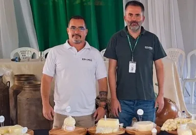 Dois homens em frente à mesa com queijos