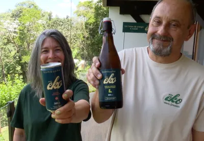 Foto mostra casal segurando as embalagens de kombucha