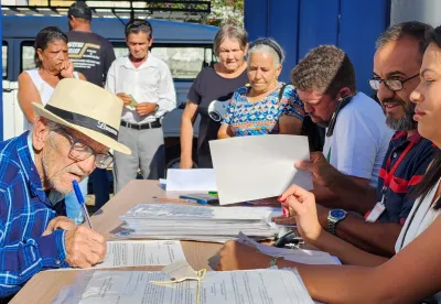 Foto mostra produtor Domingos Ribeiro de Carvalho, assinando o recebimento do título