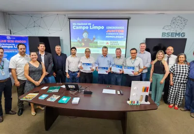 Autoridades enfileiradas seguram placa de reconhecimento