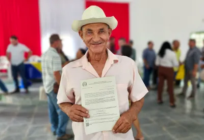 Foto mostra produtor com o título em mãos