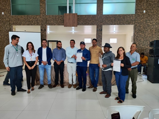 Foto mostra agricultores familiares de Rio Pardo de Minas segurando seus títulos de propriedade rural entregues pelo Governo de Minas